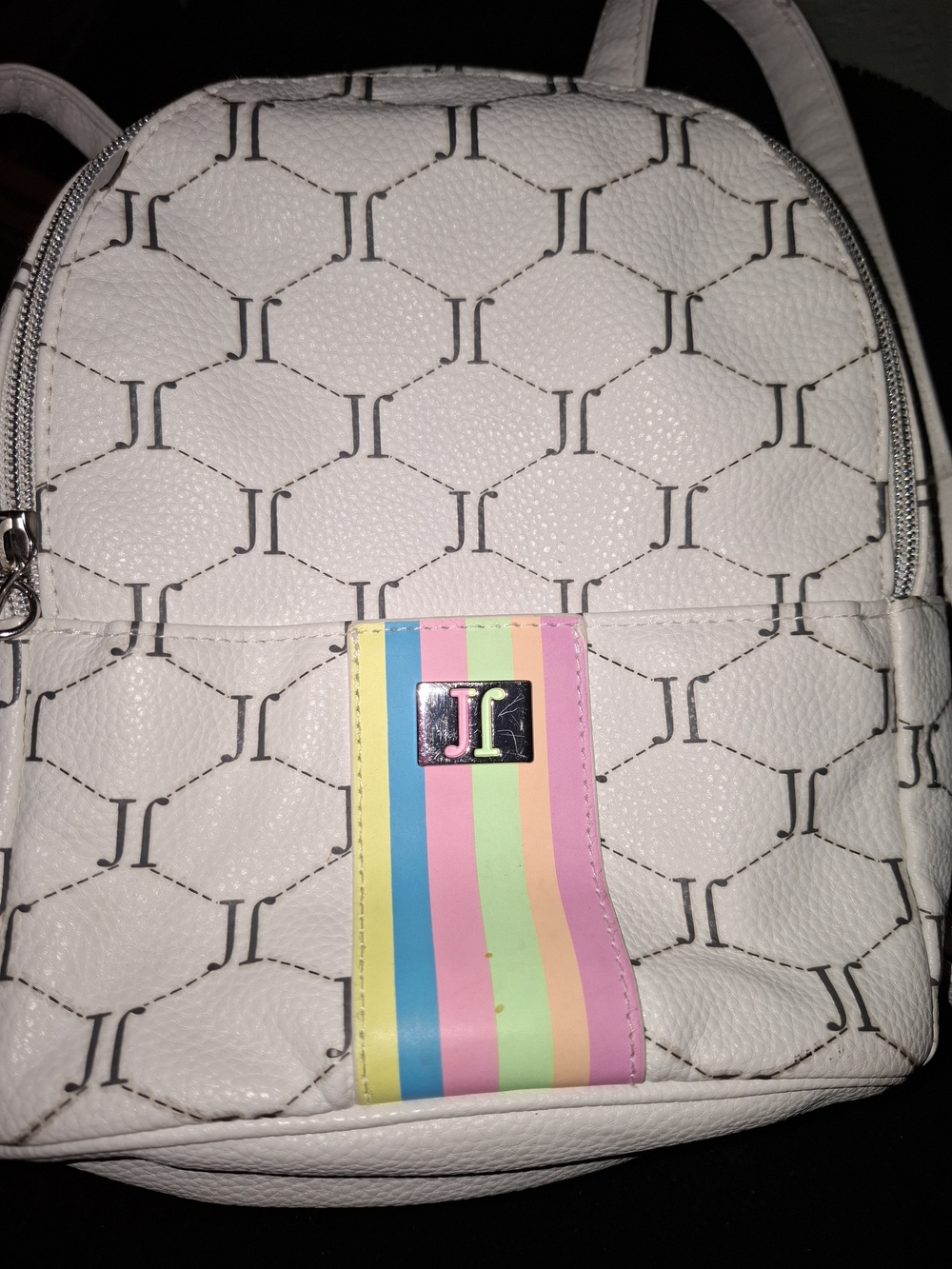 Justice mini backpack featuring an all-over "J" monogram pattern